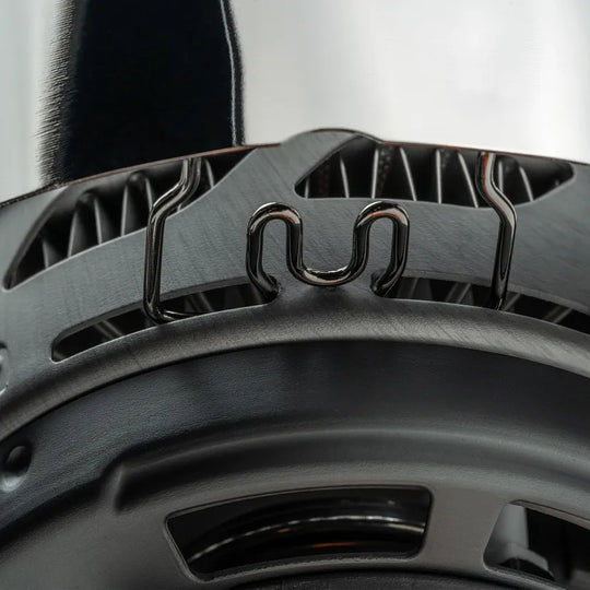 Close-up of a black car seat with a visible brand logo.