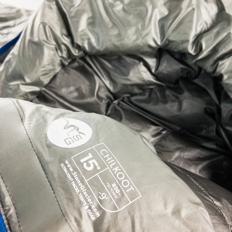 A close-up view of the product tag found on the Stone Glacier 15 Degree Chilkoot Sleeping Bag in granite grey.