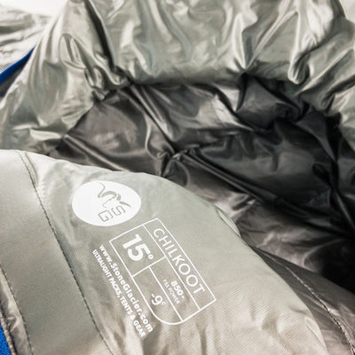 A close-up view of the product tag found on the Stone Glacier 15 Degree Chilkoot Sleeping Bag in granite grey.