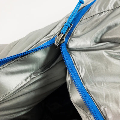 A close-up view of the zipper being partially open on the Stone Glacier 15 Degree Chilkoot Sleeping Bag in granite grey.