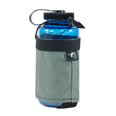 A close-up image of the Stone Glacier Hydro Holster in foliage with a blue Nalgene bottle positioned within.