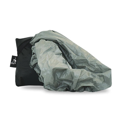 The Stone Glacier Rain Cover being partially pulled out of its storage stuff sack.