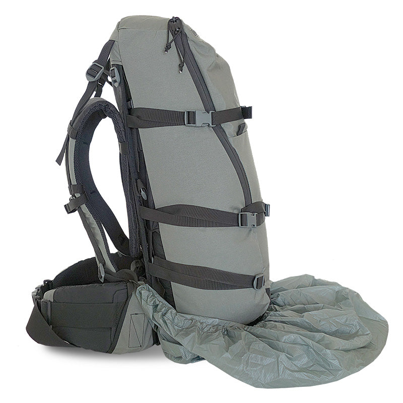 A side-view of the Stone Glacier Rain Cover being partially placed over a Stone Glacier backpack.