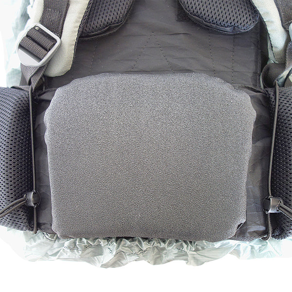 A close-up view of the butt pad found on a Stone Glacier backpack that shows the Stone Glacier Rain Cover installed near the bottom.